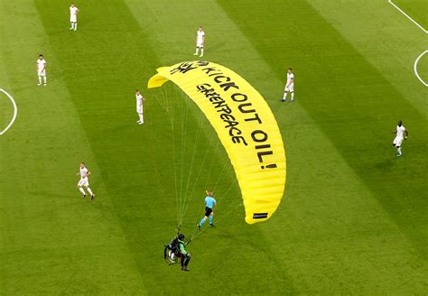 Greenpeace activists fined for crash-landing a parachute in stadium before Germany-France match
